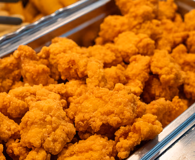 Tray full of crispy fried chicken pieces.