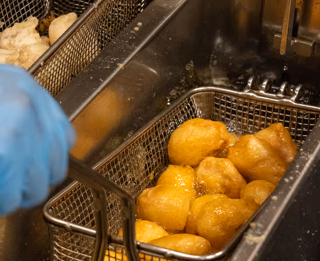 Fried food being lifted from deep fryer.